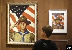 FILE - An 11-year-old boy looks over a Boy Scout-themed Norman Rockwell exhibition at the Church History Museum in Salt Lake City, Utah, July 22, 2013.