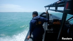 馬來西亞拯救人員正在進行搜救失事木船的工作
