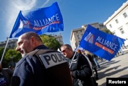 French police, holding labor union banners, rally at the courthouse in Marseille as part of a national protest against what they contend is inadequate judicial support, Oct. 14, 2015.