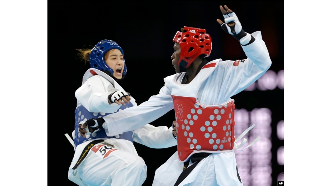 FILE - South Korea's Hwang Kyung-seon fights Ivory Coast's Ruth Gbagbi, in red, during their match in the women's taekwondo competition at the 2012 Summer Olympics in London, Aug. 10, 2012.