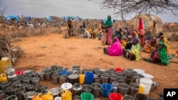 FILE - People wait for food and water in the Warder district in the Somali region of Ethiopia, Jan. 28, 2017.