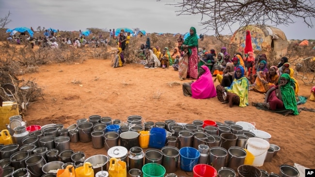 FILE - People wait for food and water in the Warder district in the Somali region of Ethiopia, Jan. 28, 2017.
