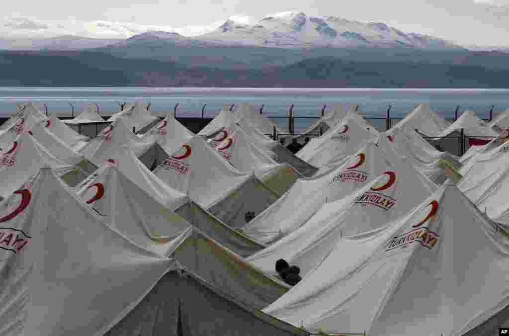 A man walk between tents set up as relief shelters for earthquake victims in Ercis, near the eastern Turkish city of Van, October 27, 2011. (Reuters)