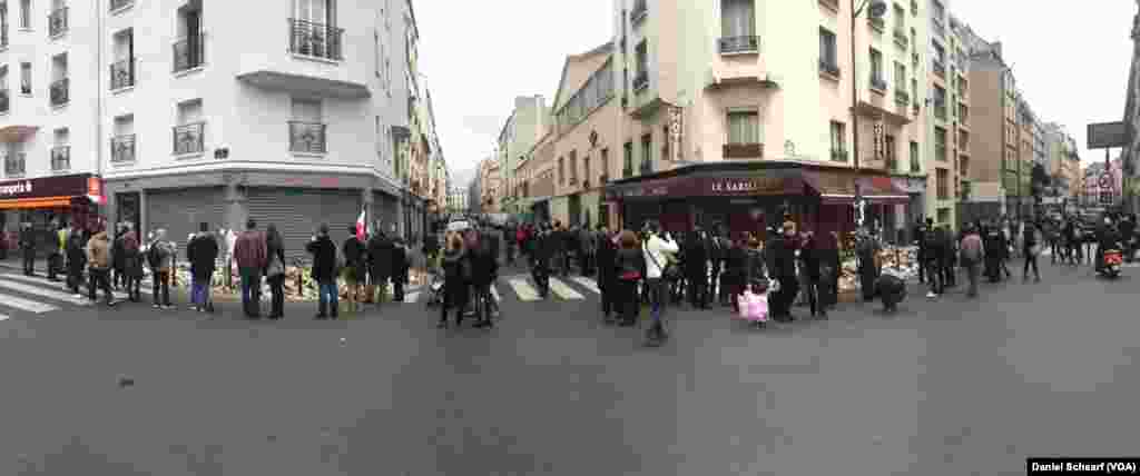 Mourners gather near Le Petit Cambodge and Le Carillon, which were the first restaurants hit in the multiple attacks across Paris Friday that left more than 120 people dead and hundreds wounded, Nov. 17, 2015.