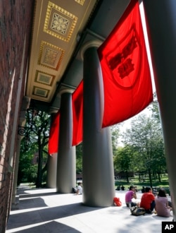 People sit on the campus of Harvard University in Cambridge, Mass. Thursday, Aug. 30, 2012. (AP Photo/Elise Amendola)