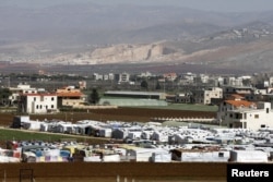 FILE - A general view shows an informal Syrian refugee camp in Tirbol village, Bekaa valley, Lebanon, March 10, 2016.