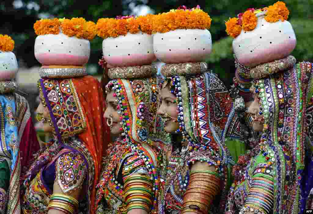 Indian folk dancers from the Panghat Group of Performing Arts pose for a photograph during a dress rehearsal for an event to mark the forthcoming Hindu festival &#39;Navaratri&#39;, or the Festival of Nine Nights, in Ahmedabad.