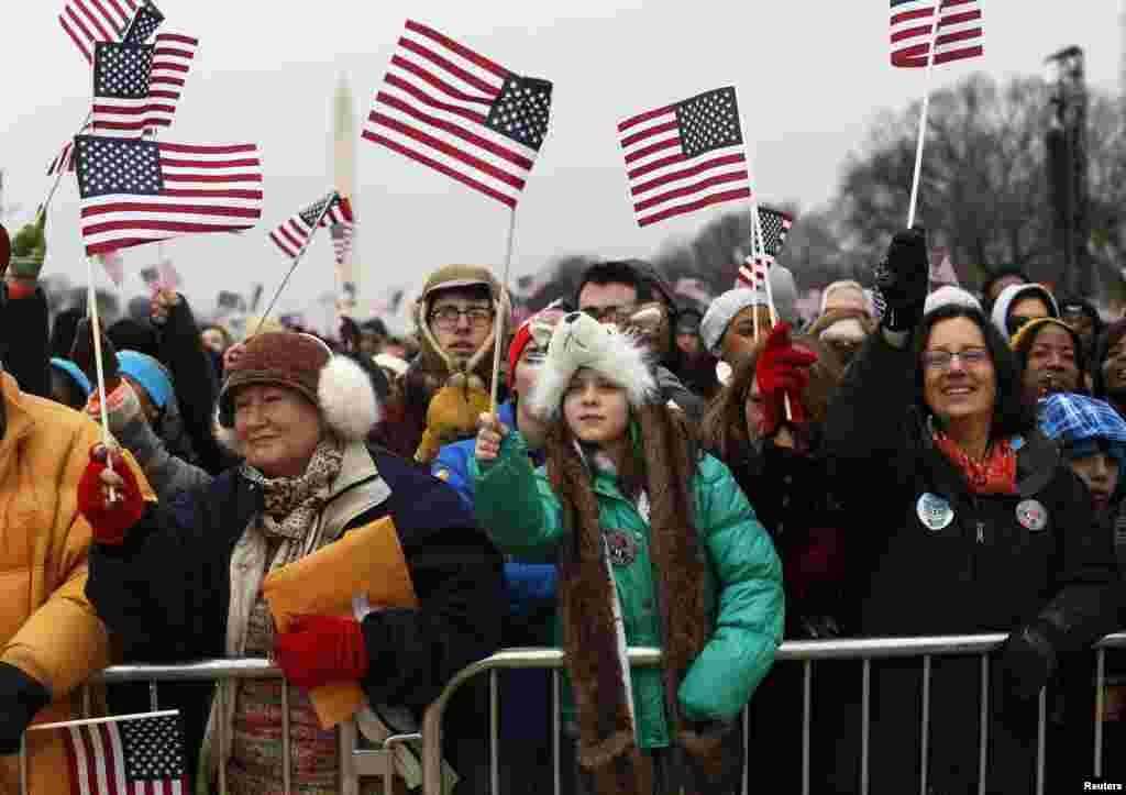 People cheer on the National Mall during the ceremonial swearing-in ceremonies of U.S. President Barack Obama and Vice President Joe Biden on the West front of the U.S. Capitol, Jan. 21, 2013. 