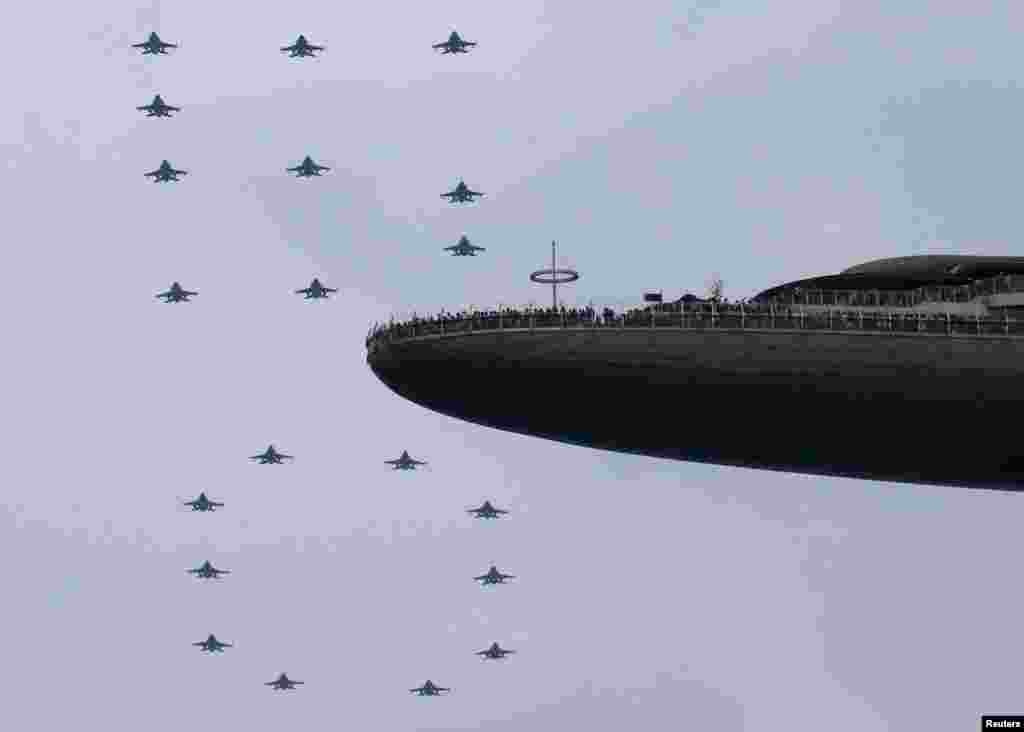 The Republic of Singapore Air Force performs a "50" formation during an aerial display in Singapore's Golden Jubilee celebrations near the central business district.