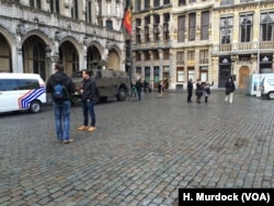 Tanks guard tourist centers in Brussels, Belgium, Nov. 22, 2015, while journalists prepare to report on an event they hope will not happen.