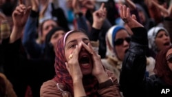 Egyptian protesters chant anti-government slogans during a rally in Tahrir Square, Cairo, Egypt, Feb. 1, 2013.