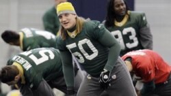 Green Back Packers linebacker A.J. Hawk stretches with teammates during practice Thursday