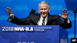 FILE - Former U.S. Marine Lt. Col. Oliver North acknowledges attendees as he gives the Invocation at the National Rifle Association-Institute for Legislative Action Leadership Forum in Dallas, May 4, 2018.