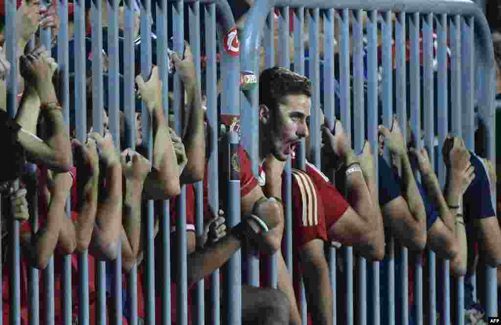 Fans of Egypt's Al Ahly cheer on their team during their African Champions League (CAF) group stage football match with Cameroon's Cotonsport, at Borg el-Arab Stadium near Alexandria, Egypt, July 8, 2017.