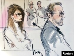 FILE - Actor Lori Loughlin, left, appears in this court sketch at a hearing for a racketeering case involving the allegedly fraudulent admission of children to elite universities, at the U.S. federal courthouse in downtown Los Angeles, California, March 13, 2019.