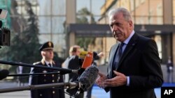 FILE - EU Migration Commissioner Dimitris Avramopoulos answers reporters' questions as he arrives for a meeting of interior ministers of the central Mediterranean contact group on migration in Rome, Italy, March 20, 2017.