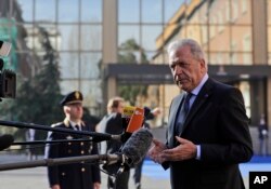 FILE - EU Migration Commissioner Dimitris Avramopoulos answers reporters' questions as he arrives for a meeting of interior ministers of the central Mediterranean contact group on migration in Rome, Italy, March 20, 2017.