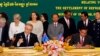 Australian Immigration Minister Scott Morrison, front left, signs a document together with Cambodian Interior Minister Sar Kheng, front right, during a signing ceremony of a controversial deal on resettlement of refugees inside the Interior Ministry in Ph