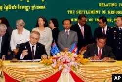 FILE - Australian Immigration Minister Scott Morrison and Cambodian Interior Minister Sar Kheng during a signing ceremony of a deal on resettlement of refugees, at the Interior Ministry in Phnom Penh, Cambodia, Sept. 26, 2014.