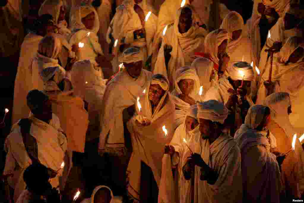 Ethiopian Orthodox pilgrims attend Christmas Eve celebration in Bete Mariam (House of Mary) monolithic Orthodox church in Lalibela, Ethiopia, Jan. 6, 2018.