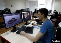 FILE - Programmer of Game Stream company, branch of Wargaming, Andrey Safronov, works on a computer in Minsk, Belarus, March 18, 2016.