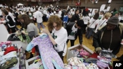 Volunteers for The Salvation Army sort children's pajamas for donation at a Greater Philadelphia Martin Luther King Day of Service event at Girard College in Philadelphia, January 17, 2011.