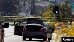 A car, allegedly used by the gunman who killed one at the Congregation Chabad synagogue in Poway, is pictured, a few hundred feet from the Interstate 15 off-ramp north of San Diego, California, April 27, 2019.
