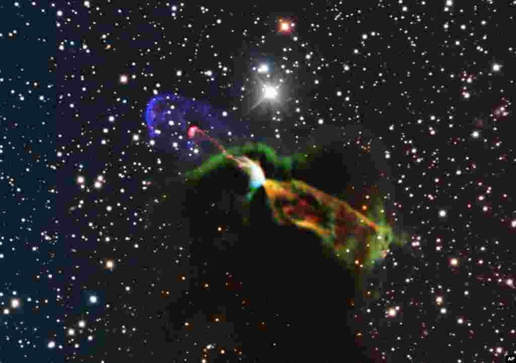 This image made available by the European Southern Observatory using radio and visible light frequencies shows the Herbig-Haro object HH 46/47. The orange and green, lower right, of the newborn star reveal a large energetic jet moving away from the Earth. To the left, in pink and purple, the visible part of the jet is seen, streaming partly towards the Earth.