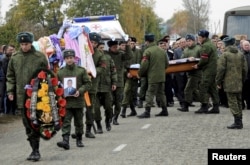 Russian servicemen carry the coffin of Vadim Kostenko, one of the Russian air force's support staff in Syria, during his funeral in the village of Grechnaya Balka, north-west of Krasnodar, Russia, Oct. 28, 2015.