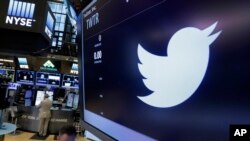 FILE - The Twitter logo appears at the post where it trades, on the floor of the New York Stock Exchange, June 17, 2016. 