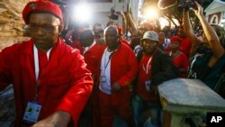 Julius Malema, center, and other members of the Economic Freedom Fighters depart after disrupting the opening session of parliament in Cape Town, South Africa, Feb. 12, 2015.