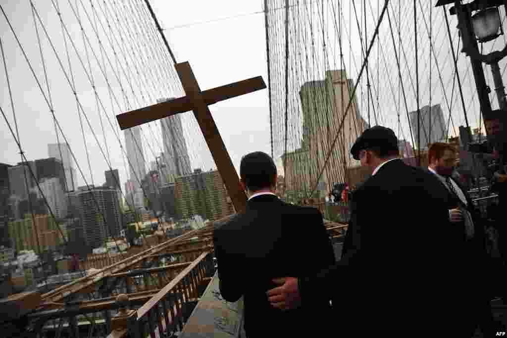 Members of the Archdiocese of New York and the Diocese of Brooklyn lead the Way of the Cross procession over the Brooklyn Bridge in New York City, April 3, 2015. 