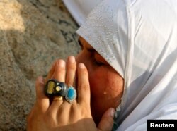 A Muslim pilgrim prays on Mount Mercy on the plains of Arafat during the annual haj pilgrimage, outside the holy city of Mecca, Saudi Arabia, Sept. 11, 2016.