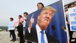 Protesters with a portrait of U.S. President Donald Trump stage a rally against the United States' policies near the U.S. embassy in Seoul, South Korea, May 25, 2018. 