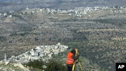 Palestinian surveyor works at the site where the first Palestinian planned city, Rawabi, will be build near the village of Atara, near the West Bank city of Ramallah (File Photo)