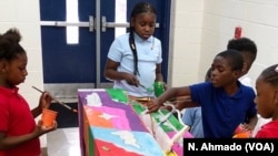 Children paint one of the pianos that will be placed in Atlanta, Georgia, during the second annual festival of Pianos for Peace festival, which runs through Sept. 22. The pianos will be donated to schools after the festival ends.