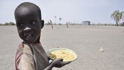 A young boy with food from a government-sponsored feeding center in central Turkana, Kenya, on August 30