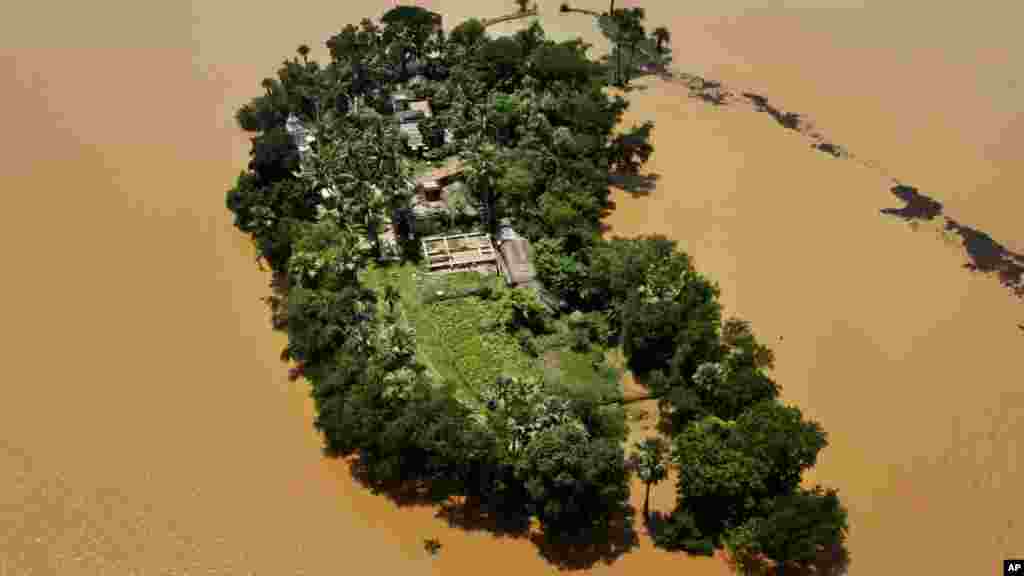 An aerial view shows houses cut-off by monsoon floods in Kendrapara district of eastern Orissa state, India.