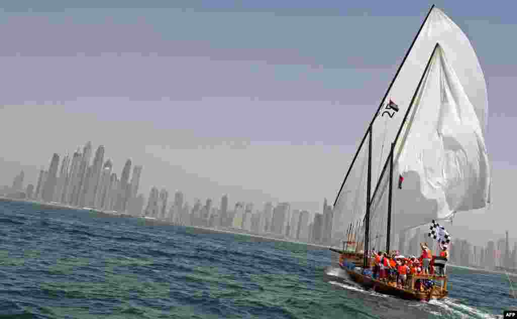 The crew of Zilzal, a dhow captained by Sheikh Hamdan bin Mohammad bin Rashid al-Maktoum, sails towards the finishing line off the coast of Dubai to win al-Gaffal traditional long-distance dhow sailing race which started at the island of Sir Bu Nair in the Gulf.