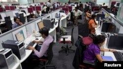 Workers are seen at their workstations on the floor of an outsourcing centre in Bangalore, February 29, 2012.