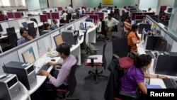 Workers are seen at their workstations on the floor of an outsourcing centre in Bangalore, February 29, 2012.