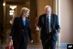 Ranking member Sen. Debbie Stabenow, D-Mich., left, ranking member of the Senate Agriculture Committee, and Sen. Pat Roberts, R-Kan., the chairman, walk to the chamber at the Capitol in Washington, April 26, 2018.