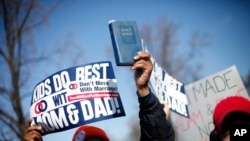 A demonstrator holds a bible while marching outside the Supreme Court in Washington, March 26, 2013.