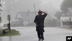Antoine White walks in the effects of Hurricane Irene in Elizabeth City, North Carolina, August 27, 2011 as the storm moves up the coast