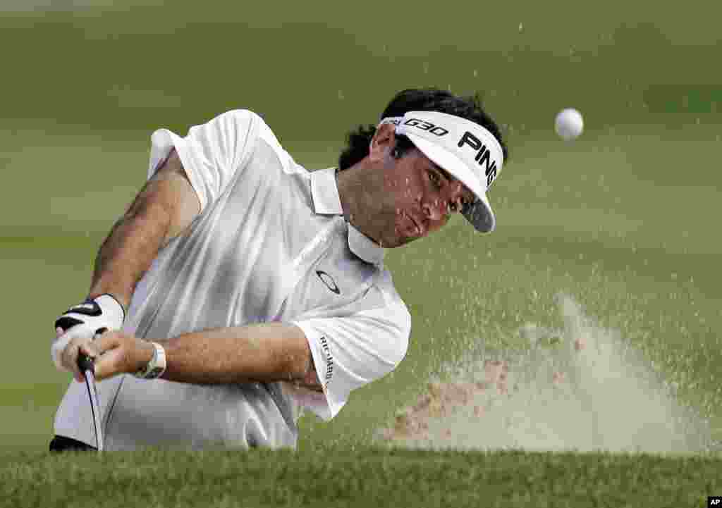 Bubba Watson hits from the sand to the 17th green during practice for the Bridgestone Invitational golf tournament in Akron, Ohio.