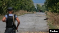 A red flag attached to a pro-Russian separatist tank is seen near a checkpoint of the Ukrainian national guard near the town of Slovyanoserbsk, Luhansk region, Sept.10, 2014.