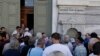 Greece Reopens Banks, Boosts Taxes, Repays Loans 