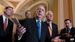 Senate Majority Leader Mitch McConnell, R-Ky., joined (L-R) by, Sen. John Barrasso, R-Wyo., Sen. John Thune, R-S.D., and Majority Whip John Cornyn, R-Texas, speaks with reporters following a closed-door strategy session on Capitol Hill in Washington.