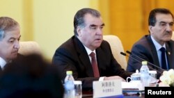 FILE - Tajikistan President Imomali Rahmon, center, attends a meeting with Chinese President Xi Jinping (unseen) at the Diaoyutai State Guesthouse in Beijing, China, Sept. 2, 2015. 