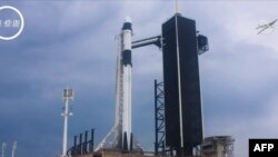 This still image taken from NASA TV, shows the SpaceX Crew Dragon capsule on the Falcon 9 rocket before launch from Launch Complex 39A in Kennedy Space Center in Florida on May 27, 2020. - The Demo-2 mission is expected to dock with the International Spac